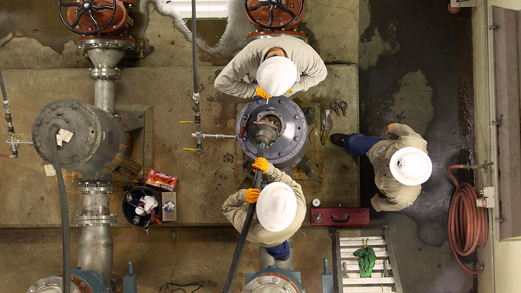 crew performing maintenance at a pump station