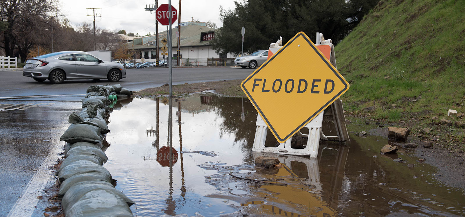Sandbags and flooded corner at intersection of Agoura Rd and and Cornell Road
